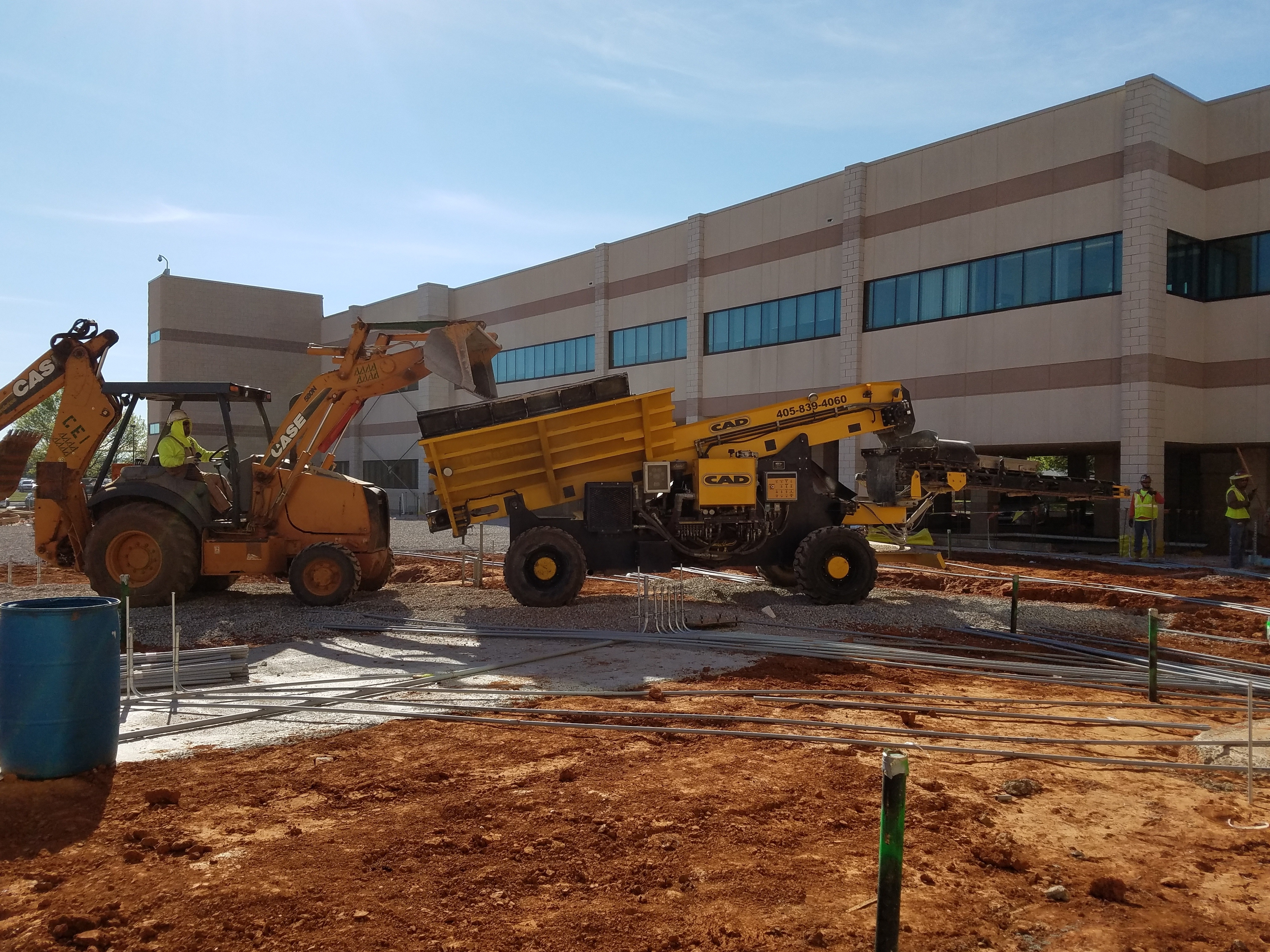 Backhoe pouring gravel in RC gravel spreader