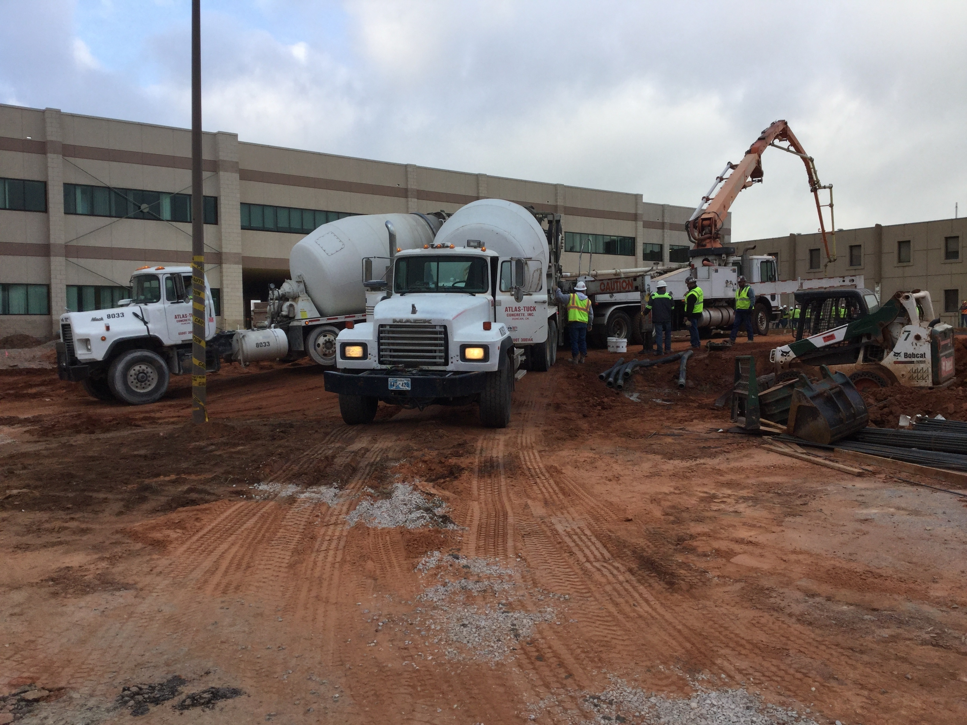 Concrete trucks pouring concrete