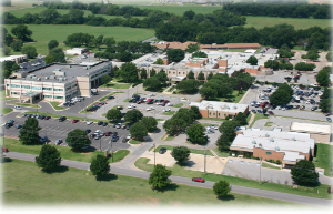 A distant view of the entire Grady Memorial Hospital surrounded by green trees.